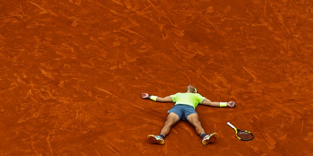 Spain's Rafael Nadal celebrates his record 12th French Open tennis tournament title after winning his men's final match against Austria's Dominic Thiem in four sets, 6-3, 5-7, 6-1, 6-1, at the Roland Garros stadium in Paris, June 9, 2019. (AP Photo/Pavel Golovkin)