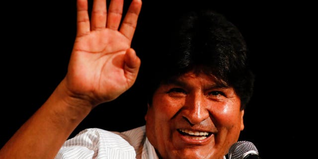 Bolivia's former President Evo Morales waves during a press conference in Buenos Aires.