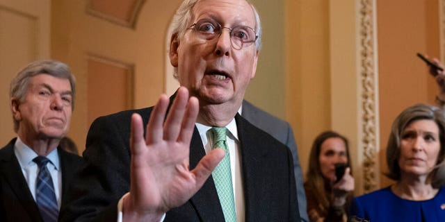 Senate Majority Leader Mitch McConnell, R-Ky., joined by Sen. Roy Blunt, R-Mo., left, and Sen. Joni Ernst, R-Iowa, dismisses the impeachment process against President Trump, saying, "I'm not an impartial juror. This is a political process," as he meets with reporters at the Capitol in Washington, Tuesday, Dec. 17, 2019. (Associated Press)