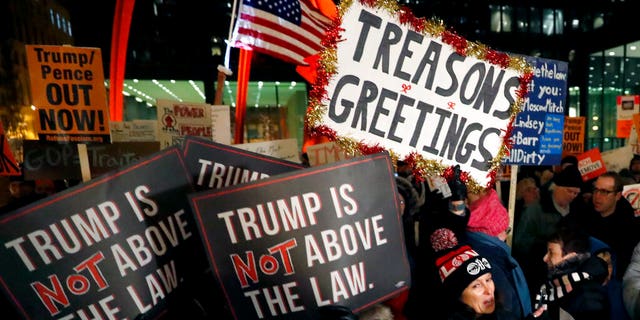 A crowd gathers on Federal Plaza for a protest against President Trump on the eve of a scheduled vote by the U.S. House of Representatives on the two articles of impeachment against the president, Tuesday, Dec. 17, 2019, in Chicago. (Associated Press)