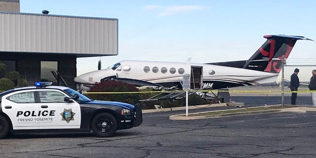 World News: A small plane sits parked after it was crashed into a fence by a 17-year-old girl Wednesday, Dec. 18, 2019, at the Fresno Yosemite International Airport in Fresno, Calif.