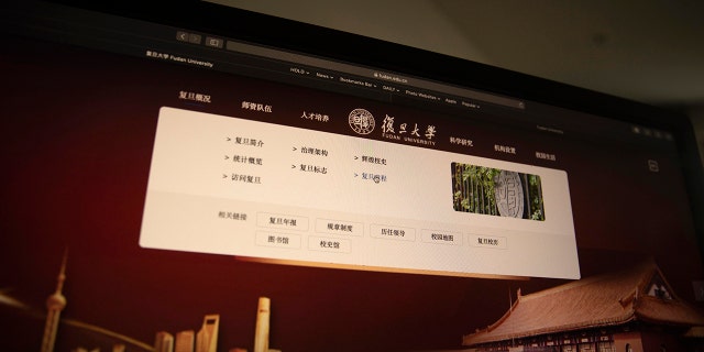 A computer screen shows the website of Fudan University with a link to the University charter in Beijing on Thursday, Dec. 19, 2019. (AP Photo/Ng Han Guan)