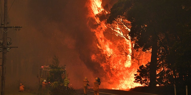 A fire truck is seen during a bushfire near Bilpin, 90 kilometers (56 miles) northwest of Sydney, Thursday, Dec. 19, 2019. Australia's most populous state of New South Wales declared a seven-day state of emergency Thursday as oppressive conditions fanned around 100 wildfires. (Mick Tsikas/AAP Images via AP)