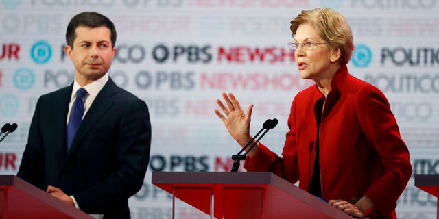 Democratic presidential candidate Sen. Elizabeth Warren, D-Mass., right, speaks as South Bend Mayor Pete Buttigieg listens during a Democratic presidential primary debate Thursday, Dec. 19, 2019, in Los Angeles. (Associated Press)