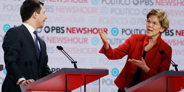 Democratic presidential candidate Sen. Elizabeth Warren, D-Mass., speaks as South Bend, Ind., Mayor Pete Buttigieg listens during a Democratic presidential primary debate Thursday in Los Angeles. (Associated Press)