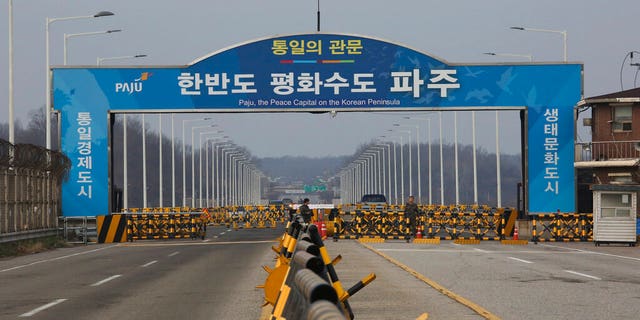In this Dec. 16, 2019, photo, South Korean army soldiers stand guard at the Unification Bridge, which leads to the Panmunjom in the Demilitarized Zone in Paju, South Korea. 