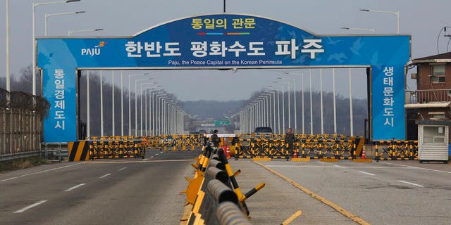 In this Dec. 16, 2019, photo, South Korean army soldiers stand guard at the Unification Bridge, which leads to the Panmunjom in the Demilitarized Zone in Paju, South Korea. 