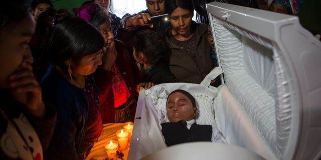 Family members pay their final respects to Felipe Gomez Alonzo in Yalambojoch, Guatemala, on Jan. 26. (AP Photo/Oliver de Ros, File)