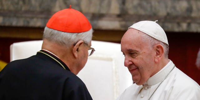 Pope Francis exchanges greetings with Cardinal Angelo Sodano, left, on the occasion of the pontiff's Christmas greetings to the Roman Curia, in the Clementine Hall at the Vatican.