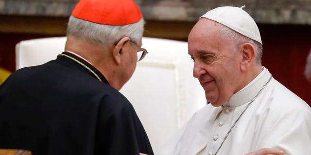 Pope Francis exchanges greetings with Cardinal Angelo Sodano, left, on the occasion of the pontiff's Christmas greetings to the Roman Curia, in the Clementine Hall at the Vatican.