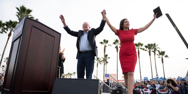 Democratic presidential candidate Sen. Bernie Sanders, I-Vt., and Rep. Alexandria Ocasio-Cortez, D-N.Y., greet the crowd during a rally in Venice, Calif., Saturday, Dec. 21, 2019. (AP Photo/Kelvin Kuo)