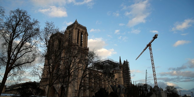A seagull flies in the sky in front of Notre Dame Cathedral in Paris, Tuesday, Dec. 24, 2019. Notre Dame Cathedral is unable to host Christmas services for the first time since the French Revolution, because the Paris landmark was too deeply damaged by this year's fire. (AP Photo/Francois Mori)