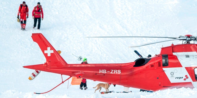 Rescue forces search for missing people after an avalanche swept down a ski piste in the central town of Andermatt, canton Uri, Switzerland, Thursday, Dec. 26, 2019. The avalanche occurred mid-morning Thursday while many holiday skiers enjoyed mountain sunshine the day after Christmas.