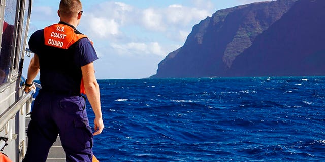 In this photo released by the U.S. Coast Guard, Coast Guard Cutter William Hart moves toward the Na Pali Coast on the Hawaiian island of Kauai on Friday, Dec. 27, 2019, the day after a tour helicopter disappeared with seven people aboard. Authorities say wreckage of the helicopter has been found in a mountainous area on the island.