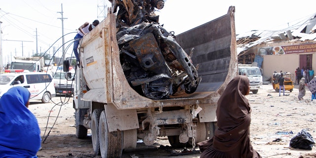 A truck carries wreckage of a car used in a car bomb in Mogadishu, Somalia, Saturday, Dec. 28, 2019. A truck bomb exploded at a busy security checkpoint in Somalia's capital Saturday morning, authorities said. It was one of the deadliest attacks in Mogadishu in recent memory. (AP Photo/Farah Abdi Warsame)
