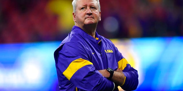 LSU Offensive Coordinator Steve Ensminger watches teams warm up before the first half of the Peach Bowl NCAA semifinal college football playoff game between LSU and Oklahoma, Saturday, Dec. 28, 2019, in Atlanta. Ensminger's daughter-in-law, Carley McCord, died in a plane crash Saturday in Louisiana on the way to the game. (AP Photo/John Amis)