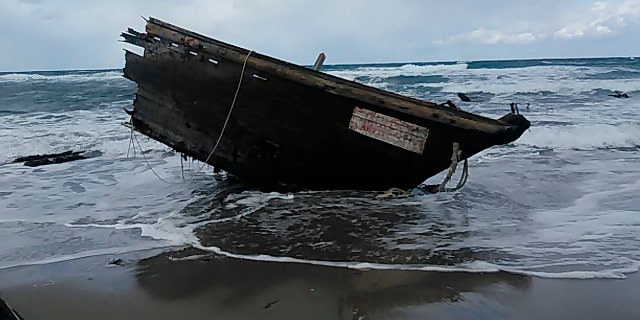This Saturday, Dec. 28, 2019, photo provided by Sado Coast Guard Station shows a part of a boat on Sado Island, Niigata Prefecture, northern Japan. The boat suspected of being from North Korea with several bodies was found on the small island, the Japanese Coast Guard said Sunday, Dec. 29, 2019. (Sado Coast Guard Station via AP)