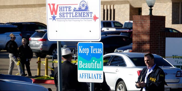 An FBI agent standing outside West Freeway Church of Christ after the shootin Sunday in White Settlement, Texas. (AP Photo/David Kent)