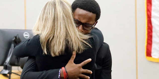 Botham Jean's younger brother Brandt Jean hugs convicted murderer and former Dallas Police Officer Amber Guyger after delivering his impact statement to her after she was sentenced to 10 years in jail, Wednesday, Oct. 2, 2019, in Dallas. (Associated Press)