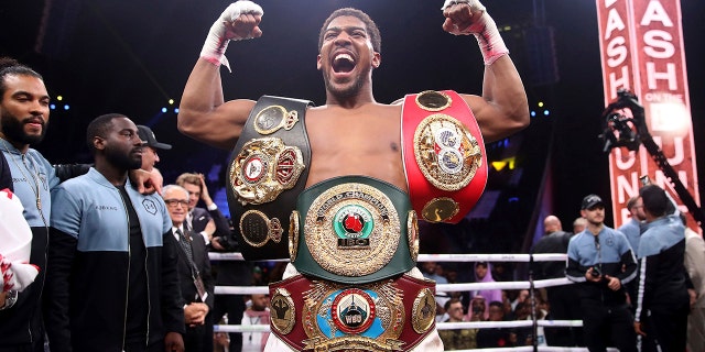 Britain's Anthony Joshua celebrates after beating Andy Ruiz Jr. on points to win their World Heavyweight Championship contest at the Diriyah Arena, Riyadh, Saudi Arabia early Sunday Dec. 8, 2019. (Nick Potts/PA via AP)