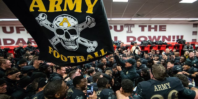 Jeff Monken, Head Coach of the Army Black Knights waves a flag in the locker room after defeating the Navy Midshipmen at Lincoln Financial Field on December 8, 2018 in Philadelphia, Pennsylvania. (Photo by Dustin Satloff/Getty Images)