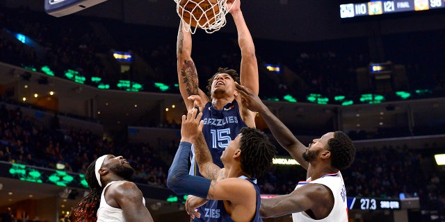 Memphis Grizzlies forward Brandon Clarke (15) dunks as Los Angeles Clippers forwards Montrezl Harrell, left, and JaMychal Green and Grizzlies guard Ja Morant watch during the second half of an NBA basketball game Wednesday, Nov. 27, 2019, in Memphis, Tenn. (AP Photo/Brandon Dill)