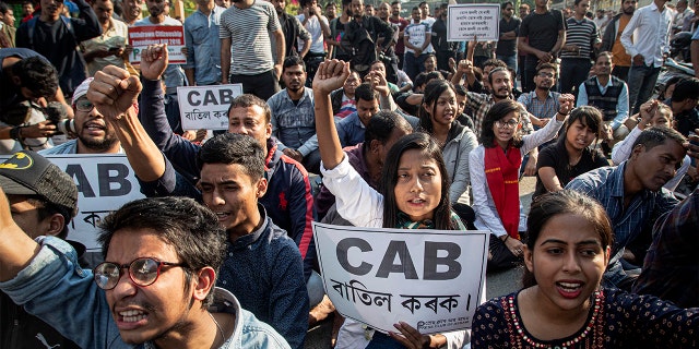 Indian protesters hold Citizenship Amendment Bill (CAB) placards during a shutdown protest against the Citizenship Amendment Bill (CAB) in Gauhati, India, Tuesday, Dec. 10, 2019. (AP Photo/Anupam Nath)