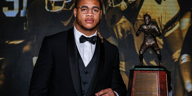 Ohio State defensive end Chase Young poses with the The 2019 Bronko Nagurski Award before the awards banquet in Charlotte, N.C., Monday, Dec. 9, 2019. (AP Photo/Nell Redmond)
