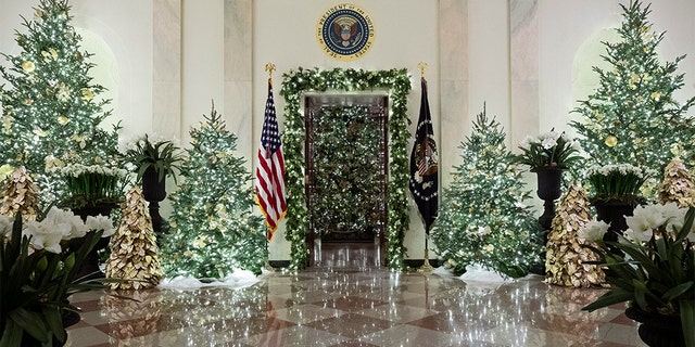 The official White House Christmas tree is decorated in the Blue Room seen through the Cross Hall, during the 2019 Christmas preview at the White House, Monday, Dec. 2, 2019, in Washington. [AP Photo/Alex Brandon)