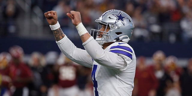 Dallas Cowboys quarterback Dak Prescott (4) celebrates a touchdown during the first half of an NFL football game against the Washington Redskins in Arlington, Texas, Sunday, Dec. 15, 2019. (AP Photo/Ron Jenkins)