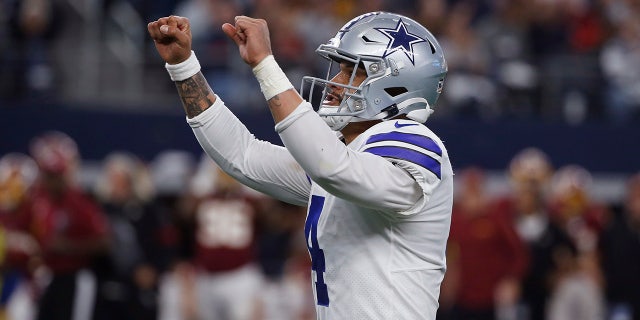 Dallas Cowboys quarterback Dak Prescott (4) celebrates a touchdown during the first half of an NFL football game against the Washington Redskins in Arlington, Texas, Sunday, Dec. 15, 2019. (AP Photo/Ron Jenkins)
