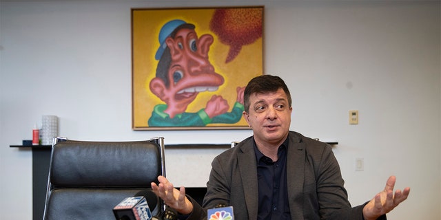 Artist David Datuna speaks to reporters during a news conference, Monday, Dec. 9, 2019, in New York. Datuna ate "Comedian," a spotty banana duct-taped to a wall by artist Maurizio Cattelan, at Art Basel Miami Saturday, Dec. 7, 2019. (AP Photo/Mary Altaffer)