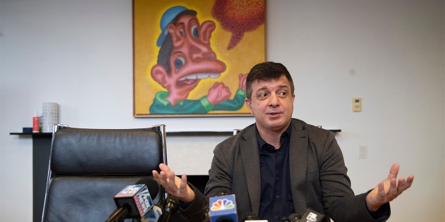 Artist David Datuna speaks to reporters during a news conference, Monday, Dec. 9, 2019, in New York. Datuna ate "Comedian," a spotty banana duct-taped to a wall by artist Maurizio Cattelan, at Art Basel Miami Saturday, Dec. 7, 2019. (AP Photo/Mary Altaffer)