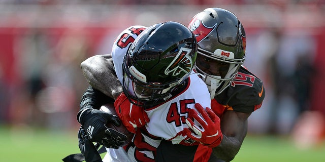 Atlanta Falcons linebacker Deion Jones (45) is stopped by Tampa Bay Buccaneers wide receiver Breshad Perriman (19) after Jones recovered a fumble by running back Ronald Jones II (27) during the first half of an NFL football game Sunday, Dec. 29, 2019, in Tampa, Fla. (AP Photo/Jason Behnken)