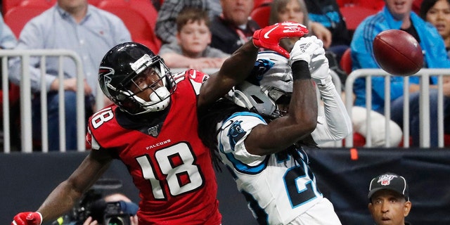 Atlanta Falcons wide receiver Calvin Ridley (18) misses a strike against Carolina Panthers cornerback Donte Jackson (26) in the first half of a December 2019 game in Atlanta.