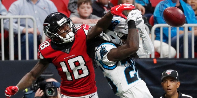 Atlanta Falcons wide receiver Calvin Ridley (18) misses a catch against Carolina Panthers cornerback Donte Jackson (26) during the first half of a December 2019 game in Atlanta.