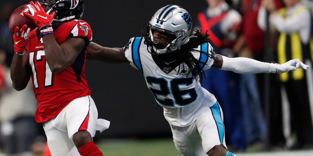 Atlanta Falcons wide receiver Olamide Zaccheaus (17) makes a catch against Carolina Panthers cornerback Donte Jackson (26) during the second half of an NFL football game, Sunday, Dec. 8, 2019, in Atlanta. ran for a touchdown on the play. Zaccheaus(AP Photo/John Bazemore)