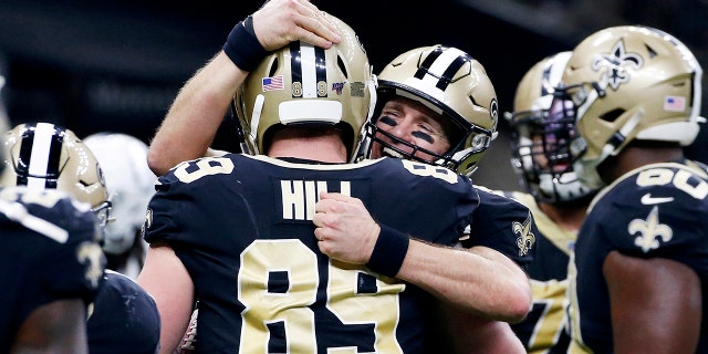 New Orleans Saints quarterback Drew Brees (9) celebrates his touchdown pass to tight end Josh Hill (89), which broke the NFL record for career touchdown passes, surpassing Peyton Manning, in the second half of an NFL football game against the Indianapolis Colts in New Orleans, Monday, Dec. 16, 2019. (AP Photo/Butch Dill)