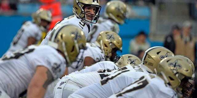 New Orleans Saints quarterback Drew Brees (9) lines for a play against the Carolina Panthers during the first half of an NFL football game in Charlotte, N.C., Sunday, Dec. 29, 2019. (AP Photo/Mike McCarn)