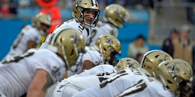 New Orleans Saints quarterback Drew Brees (9) lines for a play against the Carolina Panthers during the first half of an NFL football game in Charlotte, N.C., Sunday, Dec. 29, 2019. (AP Photo/Mike McCarn)