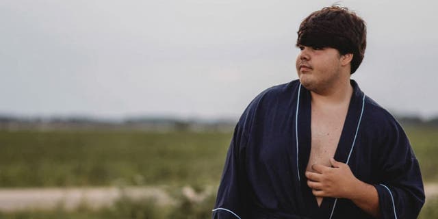 Photographer Tiffany Clark didn’t initially expect anything out of the ordinary while recently preparing her cousin, high schooler Evan Dennison, pictured, for his close-up. (Courtesy of Chaos and Clark Photography)
