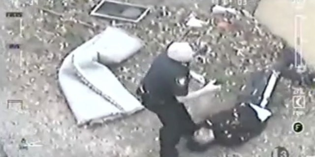 Image from video shot by a police helicopter shows Fort Worth Police Chief Ed Kraus nabbing a suspect after a foot chase through backyards and over fences.