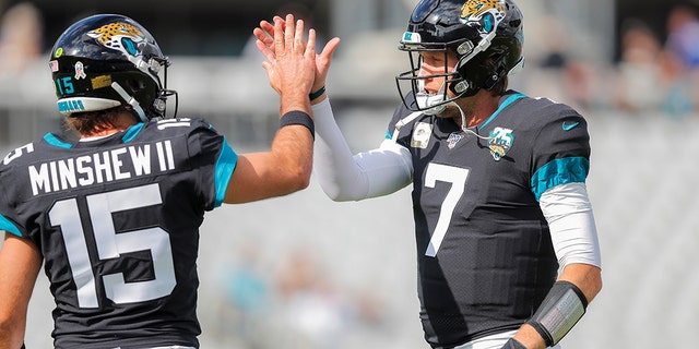 Gardner Minshew #15 of the Jacksonville Jaguars and Nick Foles #7 warm up before the start of a game against the Tampa Bay Buccaneers. (Photo by James Gilbert/Getty Images)