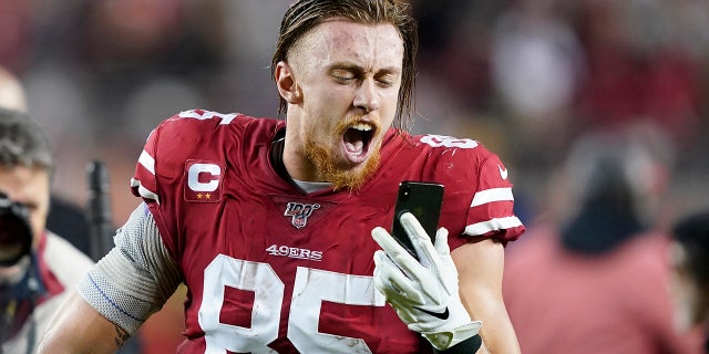 San Francisco 49ers tight end George Kittle yells into a phone while celebrating after the 49ers defeated the Los Angeles Rams in an NFL football game in Santa Clara, Calif., Saturday, Dec. 21, 2019. (AP Photo/Tony Avelar)