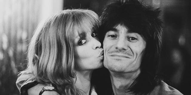 English rock musician, songwriter, multi-instrumentalist, artist, author Ronnie Wood of rock band The Rolling Stones with his partner Jo, UK, 26th July 1979.