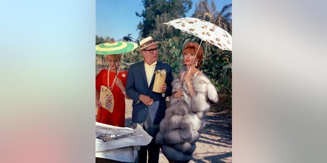Pictured at left are Natalie Schafer (as Mrs. Lovey Howell), Jim Backus (as Thurston Howell III), Tina Louise (as Ginger).  