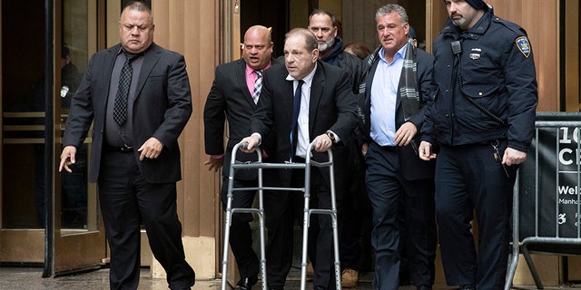 Harvey Weinstein, center, leaves court following a hearing in New York on Dec. 11.