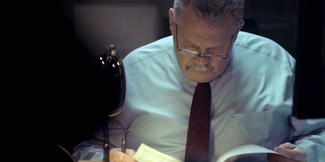 Det. Fil Waters reading evidence.