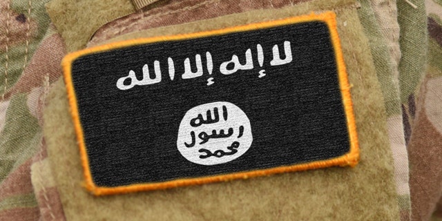 A patch of the ISIS flag on a soldier's uniform.