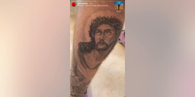 Justin Bieber's Jesus Christ tattoo on his left calf.